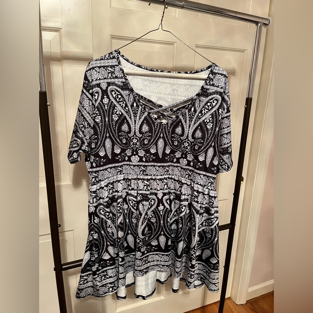 Short sleeve shirt with black and white patterned print.